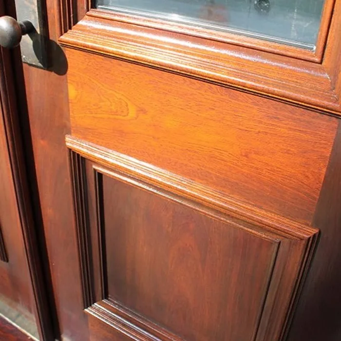Close-up of a custom stained wood front door installation