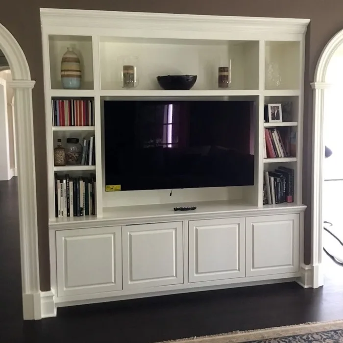 Custom white built-in bookshelves and entertainment cabinetry