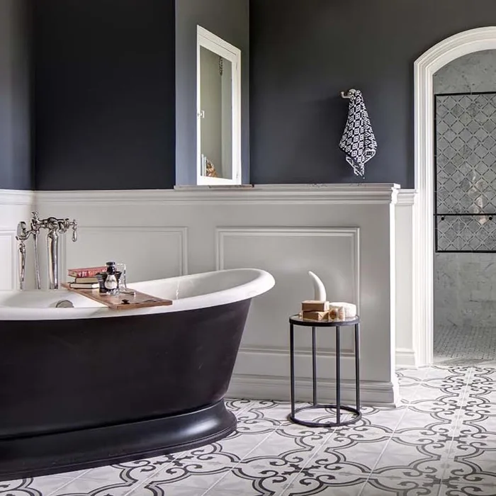 Elegant remodeled bathroom with black soaking tub and patterned tile floor